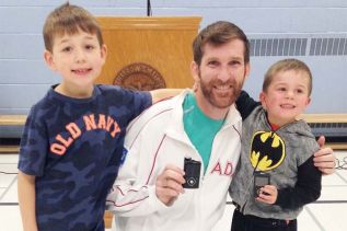 L to R: Quinn, Kieran’s older brother, Chris Jarvis, Kieran Palmer. Chris and Kieran are holding the insulin pumps they wear all the time.